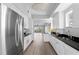 Kitchen featuring stainless steel appliances, white cabinets, and a clear view to the open concept living area at 12033 Gandy N Blvd # 145, St Petersburg, FL 33702