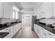 Modern kitchen with sleek white cabinets, granite countertops, and stainless steel appliances at 12033 Gandy N Blvd # 145, St Petersburg, FL 33702