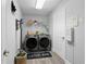 Well-organized laundry room with front loading washer and dryer, shelving and stylish decor at 12033 Gandy N Blvd # 145, St Petersburg, FL 33702