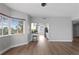 Bright and open living room featuring large windows, wood flooring, and open concept to kitchen at 12033 Gandy N Blvd # 145, St Petersburg, FL 33702
