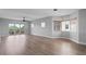 Spacious living room featuring wood-look floors, ceiling fan, and access to a private balcony at 12033 Gandy N Blvd # 145, St Petersburg, FL 33702