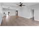Bright, open living room with light wood floors and a ceiling fan at 12033 Gandy N Blvd # 145, St Petersburg, FL 33702