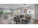 Bright living and dining area with modern furnishings, a ceiling fan, and sliding glass doors to the balcony at 12033 Gandy N Blvd # 145, St Petersburg, FL 33702
