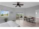 Main bedroom with light wood floors, ceiling fan, large windows and balcony access at 12033 Gandy N Blvd # 145, St Petersburg, FL 33702