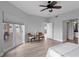 Main bedroom with light wood floors, balcony access, ceiling fan and an ensuite bathroom at 12033 Gandy N Blvd # 145, St Petersburg, FL 33702