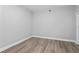 Empty room featuring hardwood floors and base trim at 12033 Gandy N Blvd # 145, St Petersburg, FL 33702