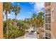 Scenic view from a condo balcony featuring lush greenery and a community pool at 12033 Gandy N Blvd # 145, St Petersburg, FL 33702