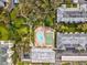 Aerial view shows community pool, shuffleboard, and building at 1235 S Highland Ave # 3-303, Clearwater, FL 33756