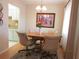 Dining room with a round table, four chairs, and a framed picture on the wall at 1235 S Highland Ave # 3-303, Clearwater, FL 33756