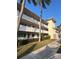 Building exterior showcasing mid-century architecture, landscaping, and ample parking at 1235 S Highland Ave # 3-303, Clearwater, FL 33756