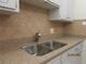 Clean kitchen features double stainless steel sink and granite countertops at 1235 S Highland Ave # 3-303, Clearwater, FL 33756