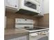 Kitchen with electric range, microwave, and granite countertops at 1235 S Highland Ave # 3-303, Clearwater, FL 33756