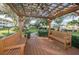 Relaxing pergola with benches overlooks community green space at 1235 S Highland Ave # 3-303, Clearwater, FL 33756