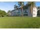 Exterior building view with palm trees and a well-maintained green lawn providing a relaxing outdoor space at 1303 S Hercules Ave # 1, Clearwater, FL 33764