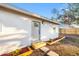 Charming house exterior with a newly installed gray door and landscaping at 1320 26Th S St, St Petersburg, FL 33712