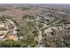 An aerial view shows the property nestled within a community, surrounded by mature trees and greenery at 170 Greenhaven Cir, Oldsmar, FL 34677