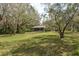 Lush backyard featuring mature trees and greenery, offering shade and a tranquil setting at 170 Greenhaven Cir, Oldsmar, FL 34677