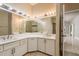 Bright bathroom features a large mirror, double sinks, and marble countertops at 170 Greenhaven Cir, Oldsmar, FL 34677