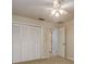 Bedroom with a ceiling fan and white closet doors at 170 Greenhaven Cir, Oldsmar, FL 34677