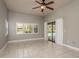 Spacious bedroom with tile flooring, and sliding doors leading to the pool area at 170 Greenhaven Cir, Oldsmar, FL 34677