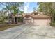 Two story home featuring an attached two car garage and a meticulously maintained lawn at 170 Greenhaven Cir, Oldsmar, FL 34677