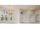 View of the home's interior, showcasing elegant tile flooring, a chandelier, and bright, neutral walls at 170 Greenhaven Cir, Oldsmar, FL 34677