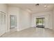 Bright living room featuring tile flooring, neutral walls and sliding doors leading to the pool area at 170 Greenhaven Cir, Oldsmar, FL 34677