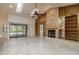 Open-concept living room with a fireplace and sliding glass doors leading to the pool area at 170 Greenhaven Cir, Oldsmar, FL 34677