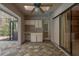 Screened patio with tiled floors and an outdoor kitchen at 170 Greenhaven Cir, Oldsmar, FL 34677