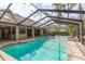An outdoor pool with spa in screened enclosure at 170 Greenhaven Cir, Oldsmar, FL 34677