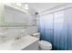 Updated bathroom with shower, toilet and vanity at 2333 Tahitian Dr, Holiday, FL 34691