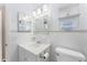 Clean bathroom with vanity, toilet, and shelving at 2333 Tahitian Dr, Holiday, FL 34691