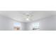 Spacious bedroom with two windows and ceiling fan at 2333 Tahitian Dr, Holiday, FL 34691