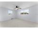 Bright bedroom with ceiling fan and two windows at 2333 Tahitian Dr, Holiday, FL 34691