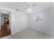 Spacious bedroom with ceiling fan and double door closet at 2333 Tahitian Dr, Holiday, FL 34691