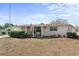 Pink single story home with covered porch and American flag at 2333 Tahitian Dr, Holiday, FL 34691