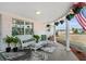 Covered porch with wicker furniture and potted plants at 2333 Tahitian Dr, Holiday, FL 34691