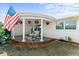 Covered porch with hanging plants and seating area at 2333 Tahitian Dr, Holiday, FL 34691