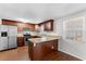 Modern kitchen with stainless steel appliances and wood cabinets at 2333 Tahitian Dr, Holiday, FL 34691