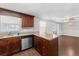 Kitchen with stainless steel dishwasher and wood cabinets at 2333 Tahitian Dr, Holiday, FL 34691