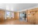 Bright sunroom with wood paneling and multiple windows at 2333 Tahitian Dr, Holiday, FL 34691
