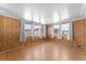 Sunroom features wood paneling and large windows at 2333 Tahitian Dr, Holiday, FL 34691