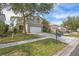 Two-story house with a white garage door and landscaping at 2445 Silvermoss Dr, Wesley Chapel, FL 33544