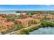 Stunning aerial view of colorful condo community surrounded by lush greenery and bay waters at 2722 Via Tivoli # 432B, Clearwater, FL 33764