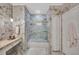 Bright bathroom with glass-enclosed shower, marble tile, and ample storage at 2722 Via Tivoli # 432B, Clearwater, FL 33764