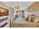 Stylish bedroom features decorative chandelier lighting, fireplace and marble flooring at 2722 Via Tivoli # 432B, Clearwater, FL 33764