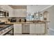 Bright kitchen features stainless appliances, granite countertops, and white cabinetry at 2722 Via Tivoli # 432B, Clearwater, FL 33764