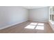 Well-lit bedroom with light wood flooring and a window at 2940 Hadleigh Ct, Clearwater, FL 33761