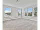Spacious bedroom with grey carpet and multiple windows at 3024 W Cass St, Tampa, FL 33609