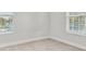Well-lit bedroom with carpet and neutral decor at 3024 W Cass St, Tampa, FL 33609